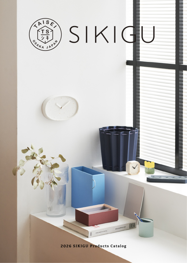 Cover of the 2026 SIKIGU Products Catalog showing the SIKIGU logo and a white desk with a clock, blue file holder, dark vase, and plants by a window.